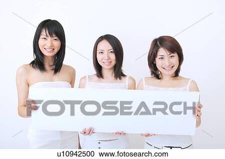 Portrait of three young women holding blank message View Large Photo Image Stock Image - Portrait of three young women holding blank message. Fotosearch