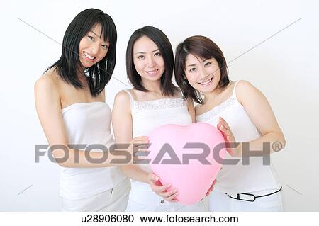 Portrait of three young women holding balloon View Large Photo Image Stock Image - Portrait of three young women holding balloon. Fotosearch