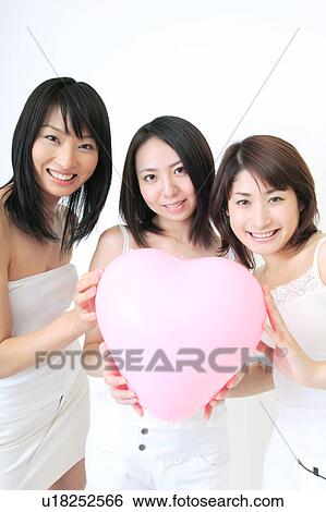 Portrait of three young women holding balloon View Large Photo Image Stock Photograph - Portrait of three young women holding balloon. Fotosearch