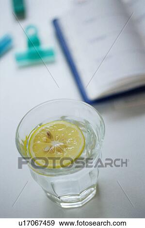 Glass of lemon water View Large Photo Image Stock Photo - Glass of lemon water. Fotosearch