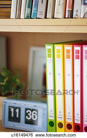 Multi colored files and clock View Large Photo Image Stock Photograph - Multi colored files and clock. Fotosearch