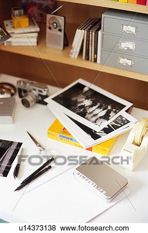 Stock Photo - Pictures and camera on desk. Fotosearch