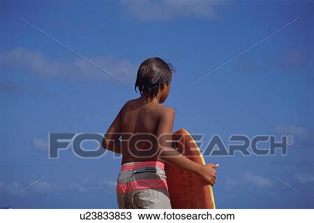 A boy holding body board View Large Photo Image Stock Image - A boy holding body board. Fotosearch