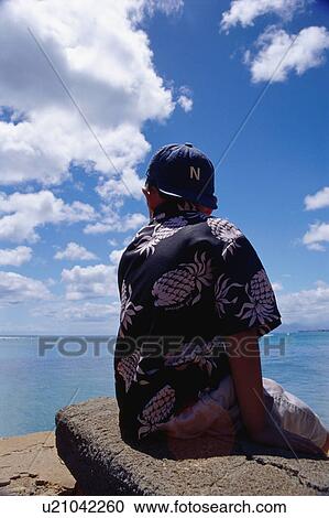 Boy sitting on rock View Large Photo Image Stock Image - Boy sitting on rock. Fotosearch