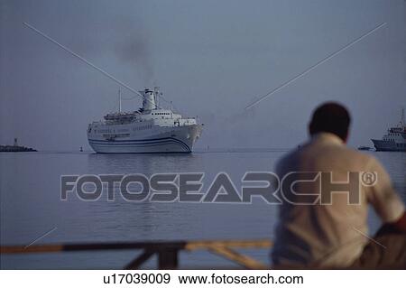 Man watching a ship going View Large Photo Image Stock Photo - Man watching a ship going. Fotosearch