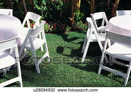 Table and chairs in garden View Large Photo Image Stock Image - Table and chairs in garden. Fotosearch