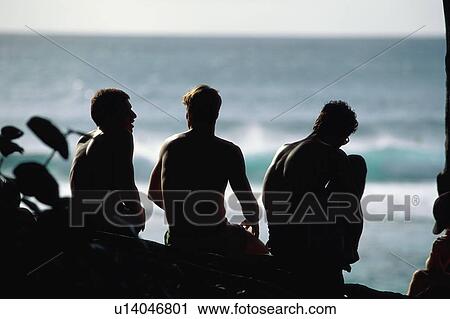 Three young surfers talking View Large Photo Image Stock Image - Three young surfers talking. Fotosearch