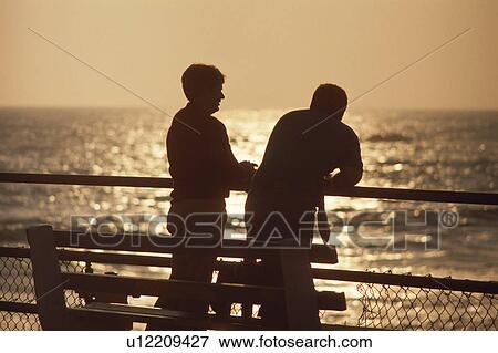 Two people talking in sunset View Large Photo Image Stock Photo - Two people talking in sunset. Fotosearch