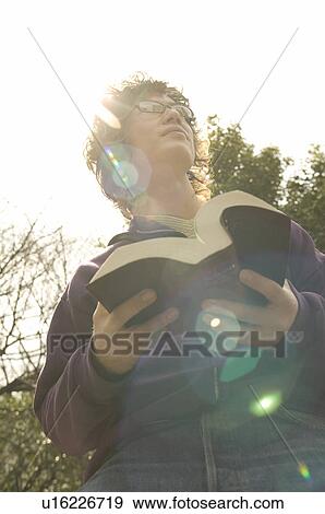 College student holding dictionary View Large Photo Image Stock Photo - College student holding dictionary. Fotosearch