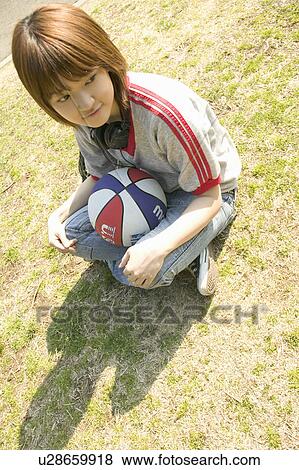 College student sitting on grass View Large Photo Image Stock Photo - College student sitting on grass. Fotosearch