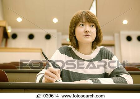 Picture - College student studying in lecture hall. Fotosearch