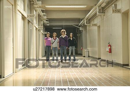Stock Photo - Four college students standing in corridor. Fotosearch