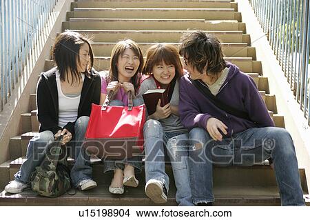 Four college students talking View Large Photo Image Picture - Four college students talking. Fotosearch