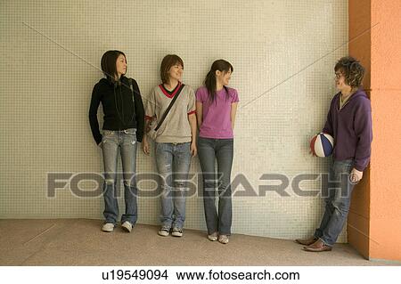 Four college students talking View Large Photo Image Picture - Four college students talking. Fotosearch