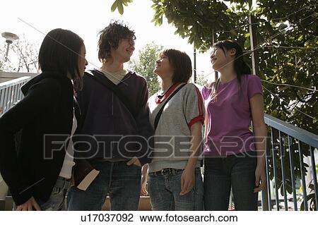 Four college students talking View Large Photo Image Stock Image - Four college students talking. Fotosearch