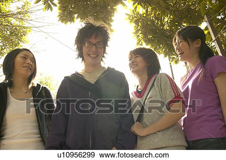 Four college students talking View Large Photo Image Stock Photo - Four college students talking. Fotosearch