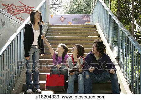 Stock Photo - Four college students talking. Fotosearch