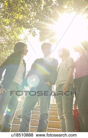Stock Photo - Four college students talking. Fotosearch