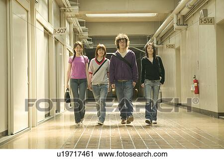 Four college students walking down corridor View Large Photo Image Stock Image - Four college students walking down corridor. Fotosearch