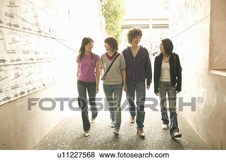 Four college students walking View Large Photo Image Stock Photo - Four college students walking. Fotosearch