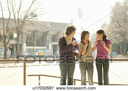 Three college students talking View Large Photo Image Stock Photo - Three college students talking. Fotosearch