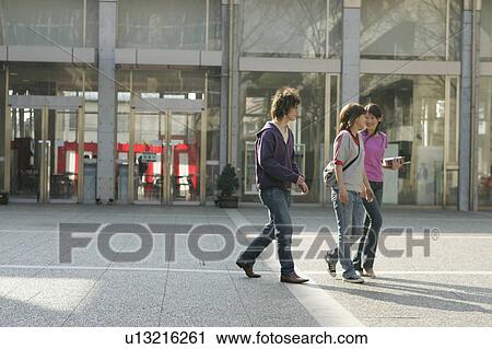 Stock Image - Three college students walking. Fotosearch