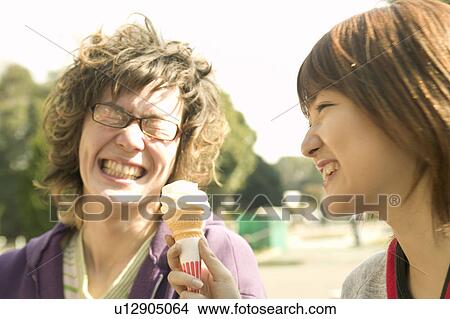 Two college students eating ice cream View Large Photo Image Picture - Two college students eating ice cream. Fotosearch