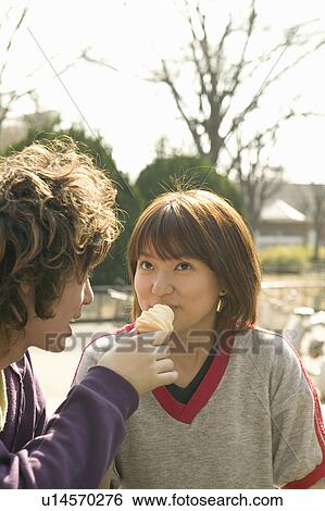 Two college students eating ice cream View Large Photo Image Stock Photograph - Two college students eating ice cream. Fotosearch