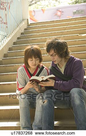 Two college students reading dictionary View Large Photo Image Stock Photo - Two college students reading dictionary. Fotosearch