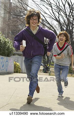 Two college students running View Large Photo Image Stock Image - Two college students running. Fotosearch