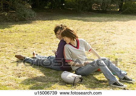 Stock Photo - Two college students sitting on grass. Fotosearch