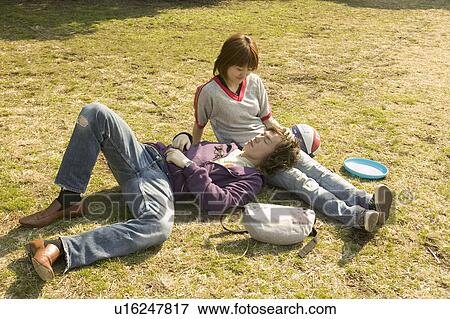 Stock Photo - Two college students sitting on grass. Fotosearch