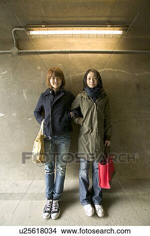 Two college students standing View Large Photo Image Picture - Two college students standing. Fotosearch