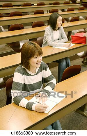 Stock Image - Two college students studying in lecture hall. Fotosearch