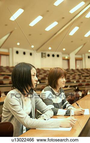 Stock Photograph - Two college students studying in lecture hall. Fotosearch