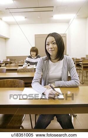 Two college students studying in classroom View Large Photo Image Stock Photography - Two college students studying in classroom. Fotosearch
