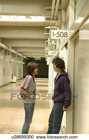 Two college students talking in corridor View Large Photo Image Stock Image - Two college students talking in corridor. Fotosearch