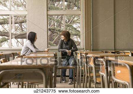 Two college students talking in classroom View Large Photo Image Stock Photography - Two college students talking in classroom. Fotosearch