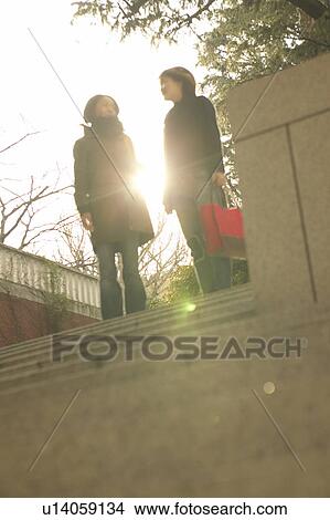 Two college students talking View Large Photo Image Picture - Two college students talking. Fotosearch