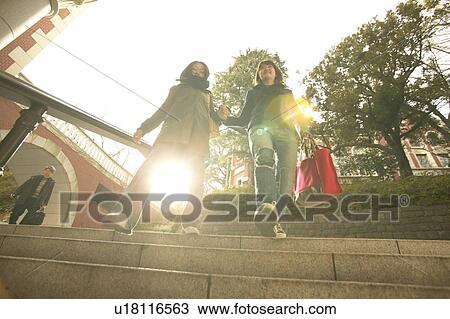 Two college students walking down stairs View Large Photo Image Stock Image - Two college students walking down stairs. Fotosearch