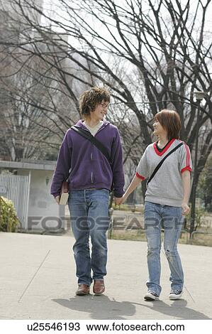Two college students walking View Large Photo Image Stock Image - Two college students walking. Fotosearch