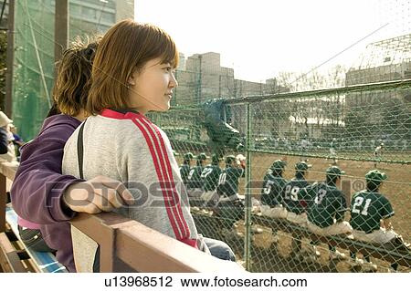 Two college students watching baseball game View Large Photo Image Stock Image - Two college students watching baseball game. Fotosearch