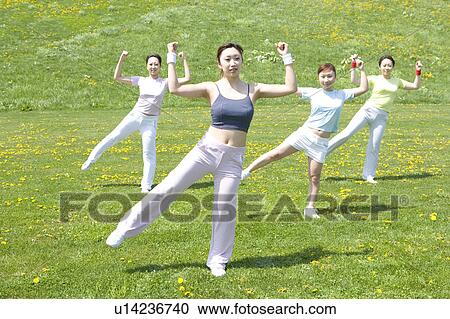 Four young women exercising in field View Large Photo Image Stock Image - Four young women exercising in field. Fotosearch