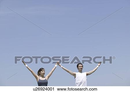 Stock Image - Two young adults exercising. Fotosearch