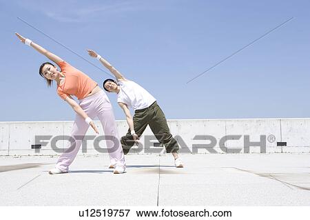 Stock Photo - Two young adults exercising. Fotosearch