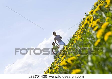 Two young women running in field View Large Photo Image Stock Image - Two young women running in field. Fotosearch