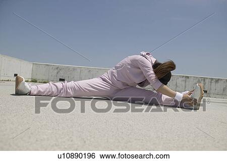 Young woman doing splits View Large Photo Image Stock Photograph - Young woman doing splits. Fotosearch