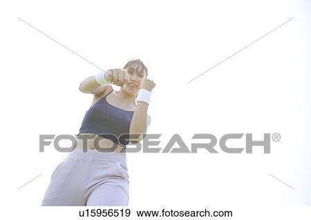 Stock Photo - Young woman exercising. Fotosearch