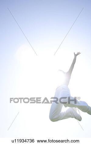 Young woman jumping View Large Photo Image Stock Photograph - Young woman jumping. Fotosearch