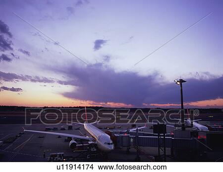 Airplane parked at airport gate View Large Photo Image Picture - Airplane parked at airport gate. Fotosearch